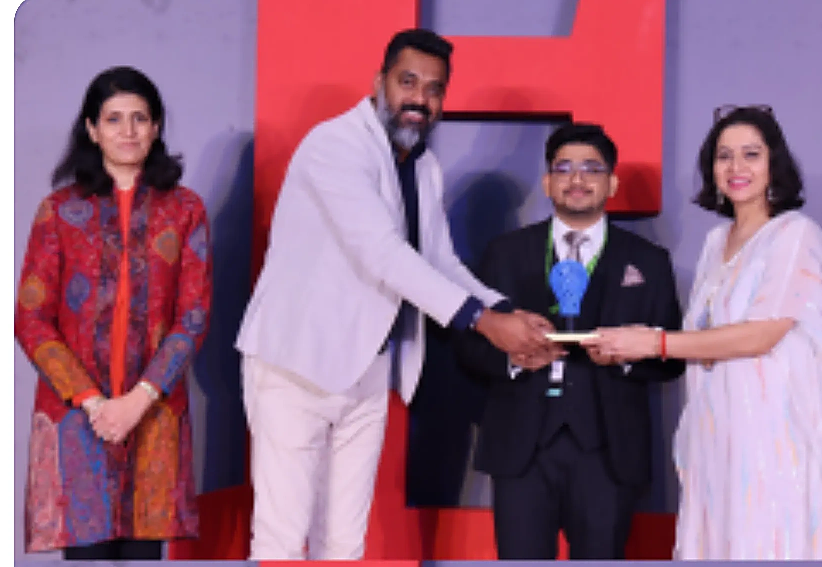 FutureIK receiving an industry award on stage